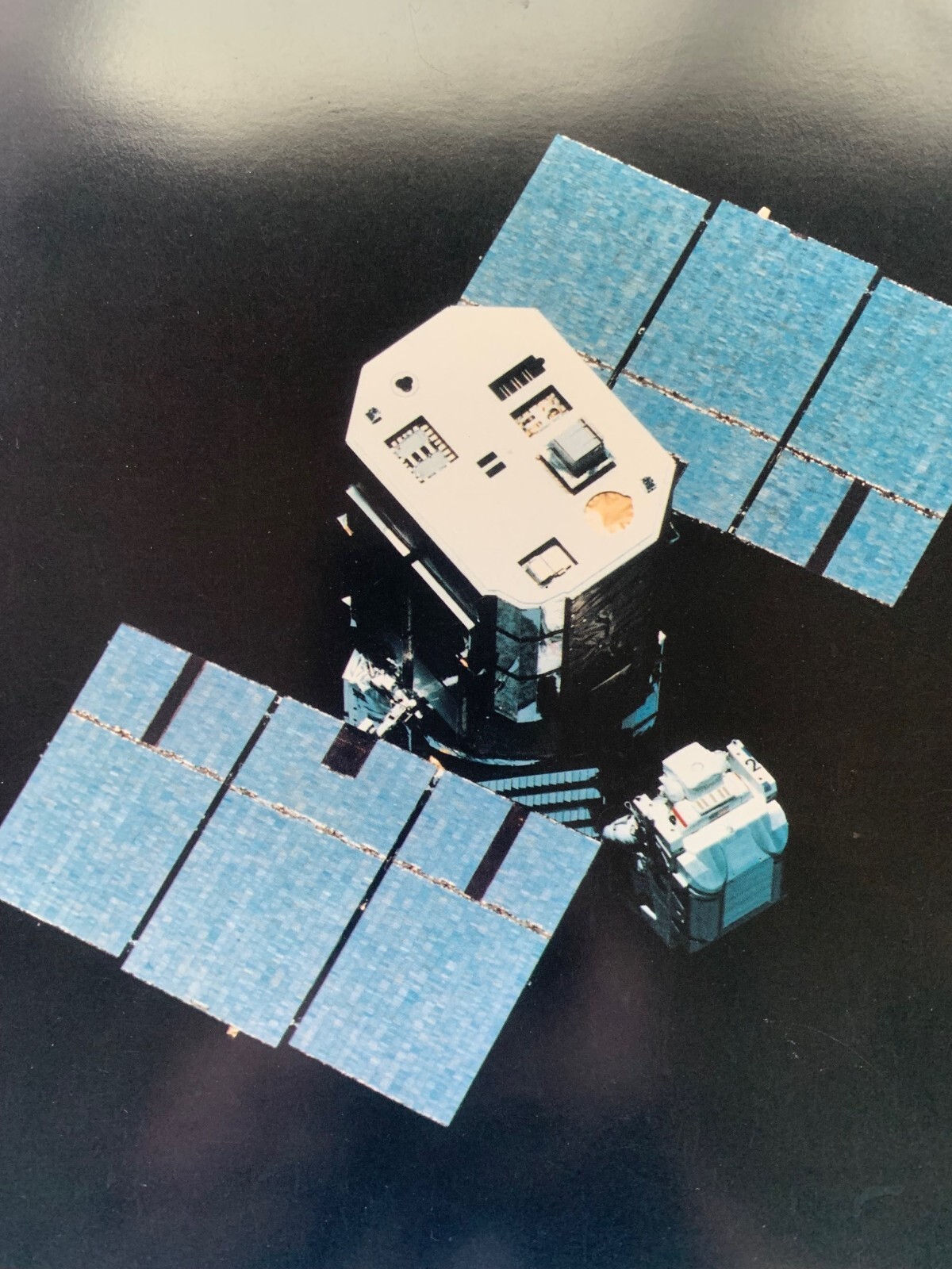 Three 8″x10″ photographs of the Manned Maneuvering Unit (MMU) in flight
