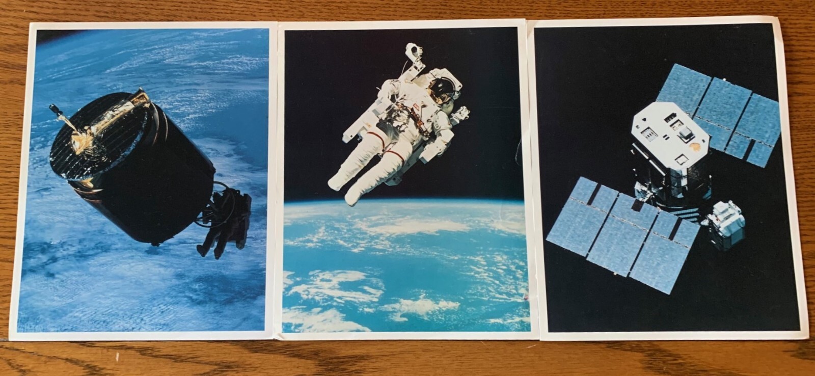 Three 8″x10″ photographs of the Manned Maneuvering Unit (MMU) in flight