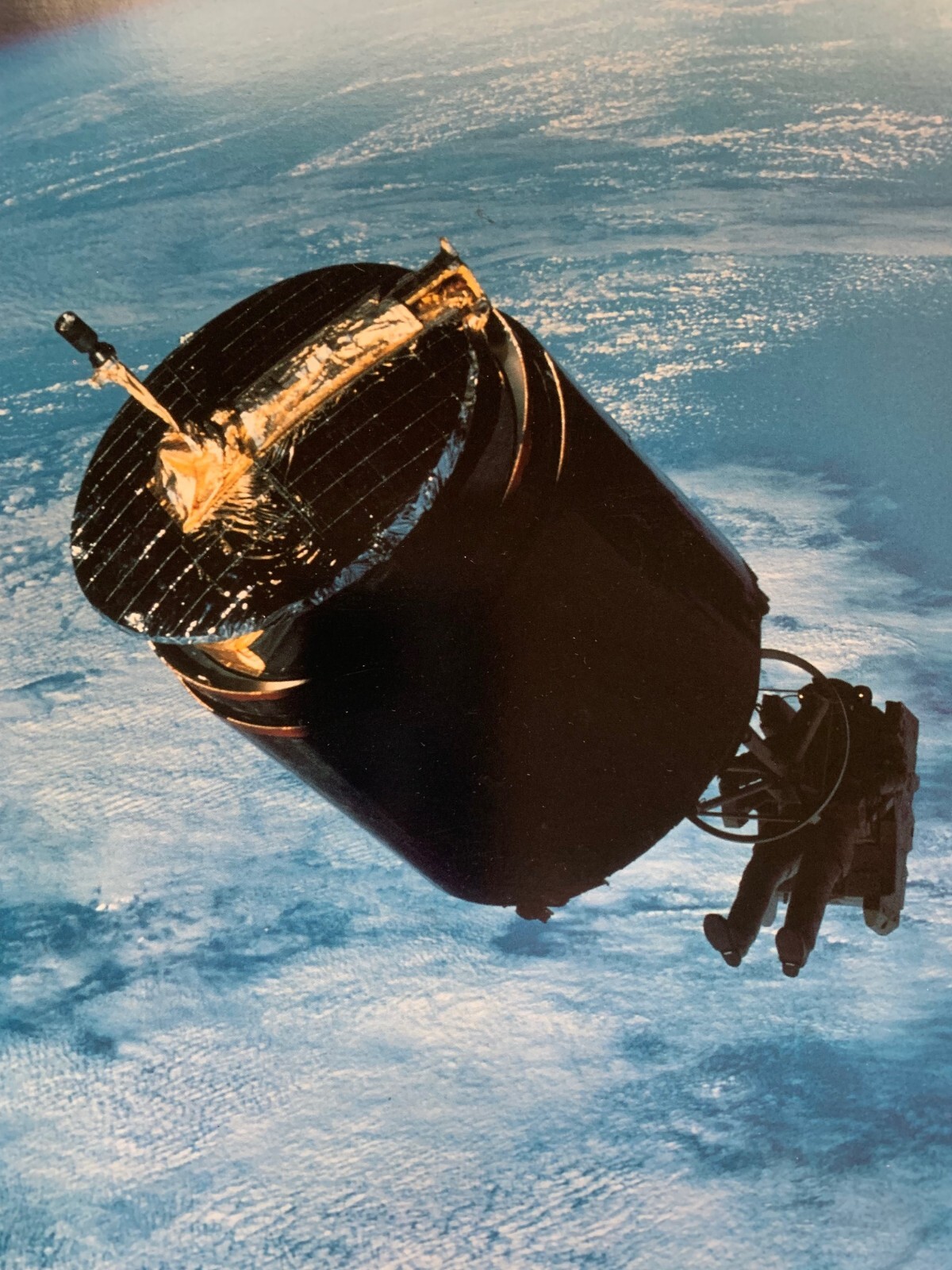 Three 8″x10″ photographs of the Manned Maneuvering Unit (MMU) in flight