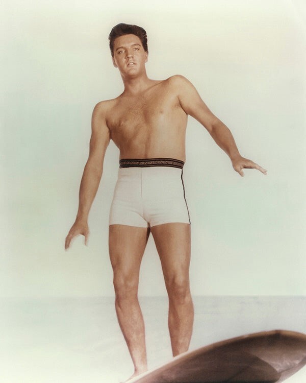 Elvis Presley posing bare-chested in swim shorts on surfboard 16×20 Poster